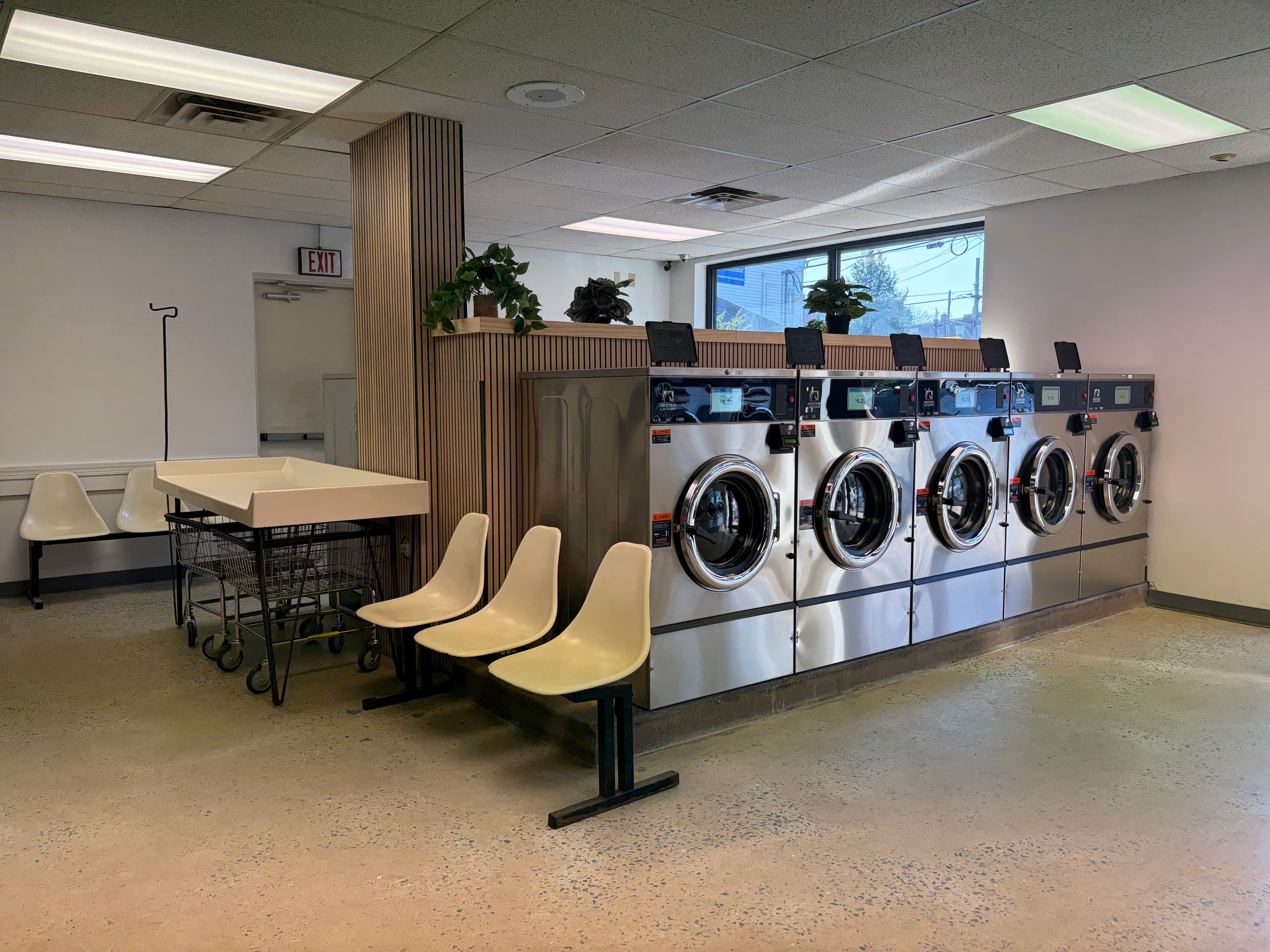 Row of 40 lb Dexter washers inside Manor Laundromat in Lancaster, PA with seating area
